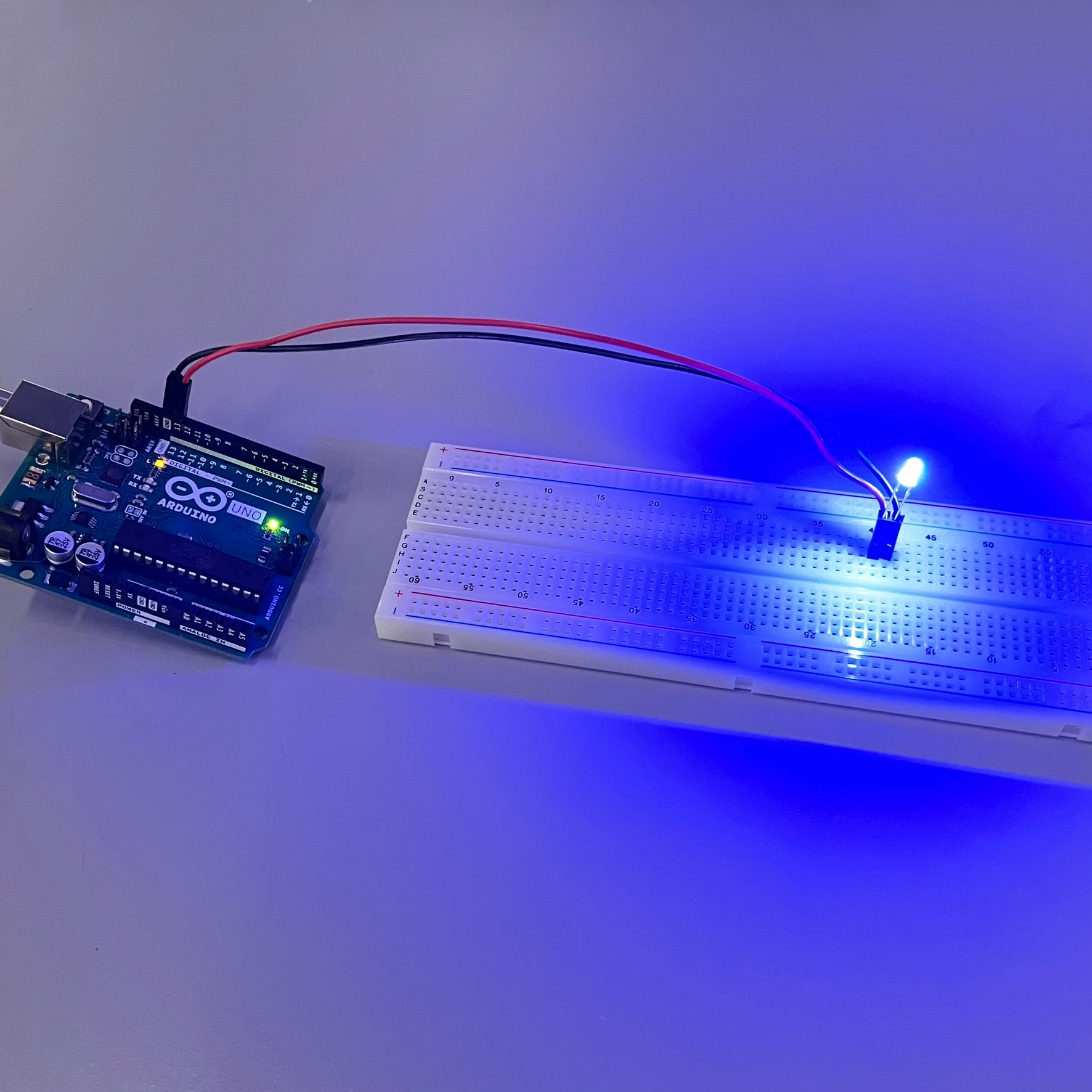 Arduino connected to a breadboard with an LED light.